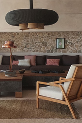 Rustic living room with stone wall by Koskaki